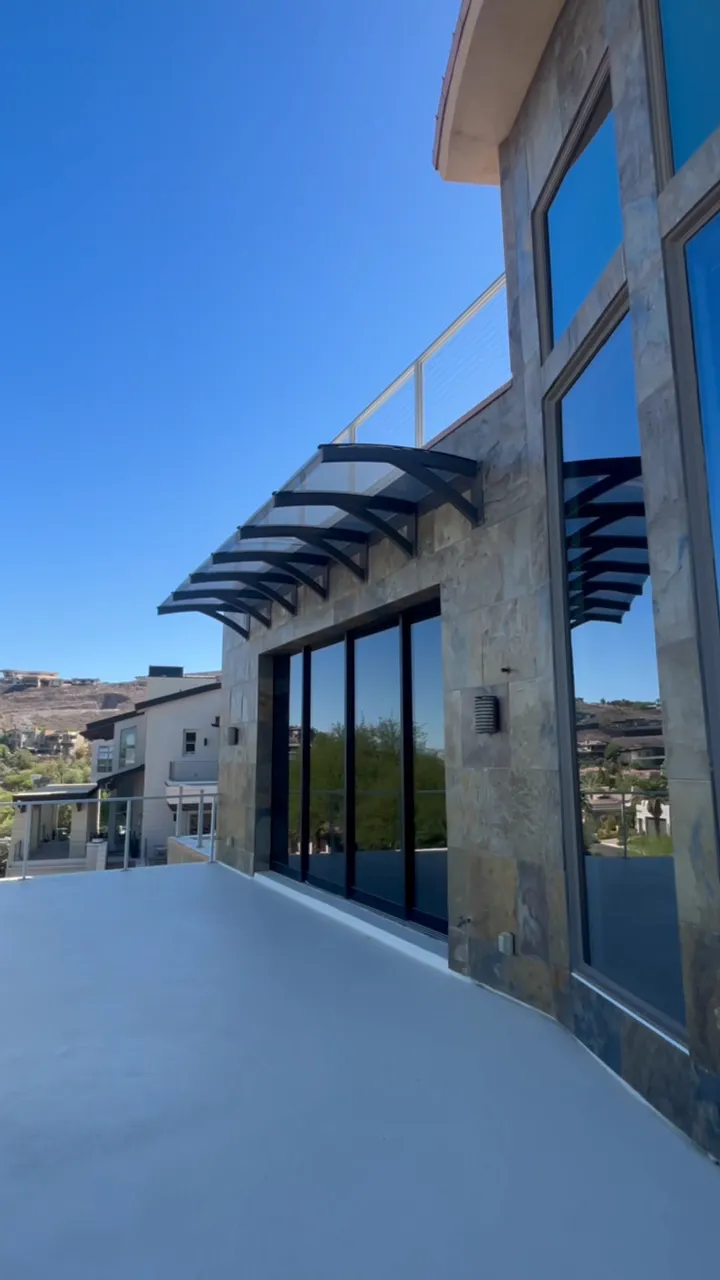 Outside the house: tall windows above a balcony