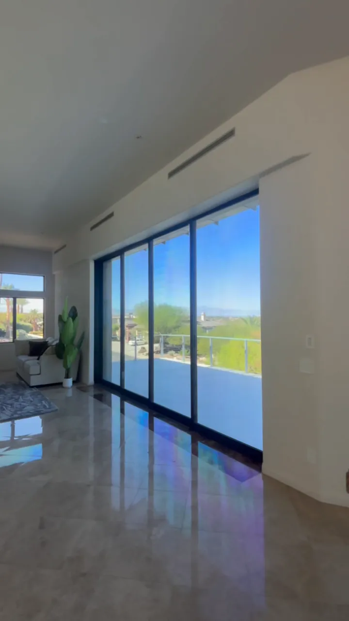 Living room with a wall of sliding glass doors onto the balcony